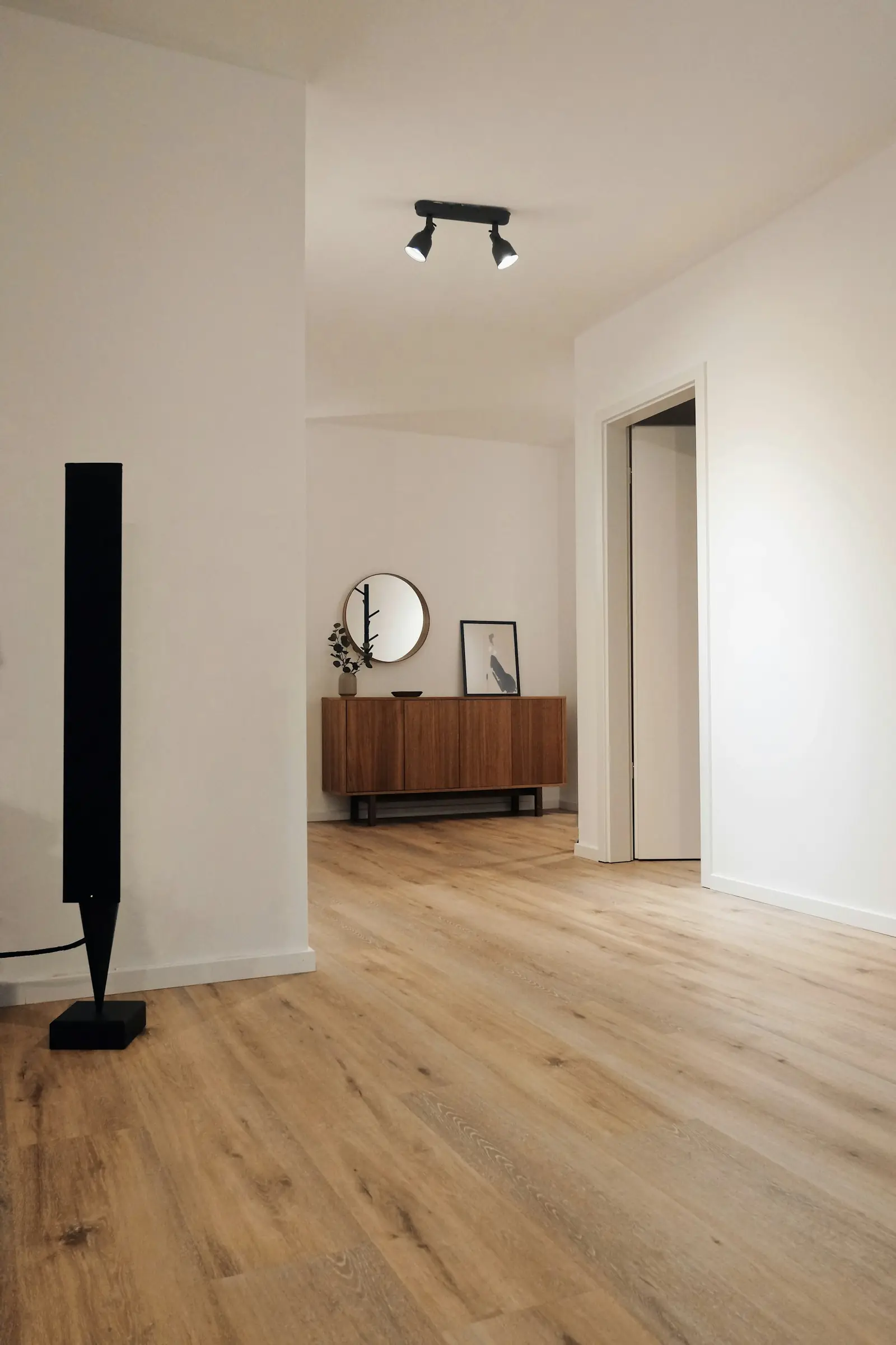 Hallway with a light wood-grain plank floor