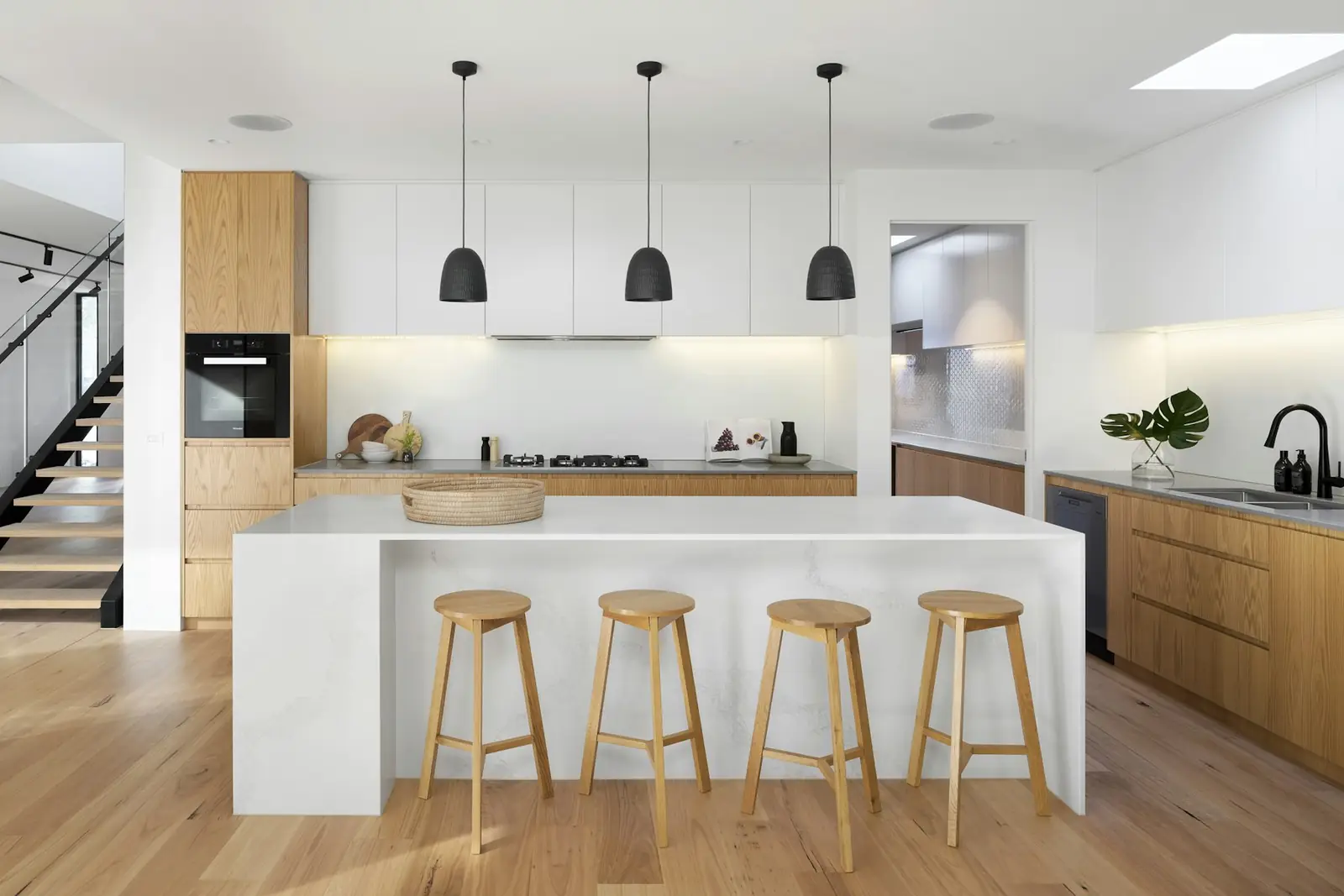 Kitchen with wood floor and white cabinets